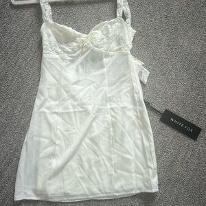 Brand new cream dress with lace pattern across the front
